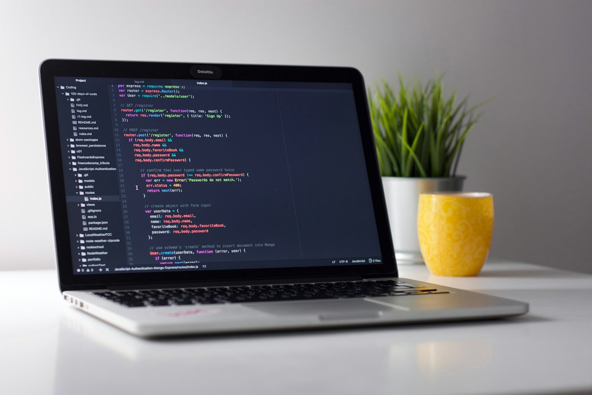 Laptop showing source code for custom business software