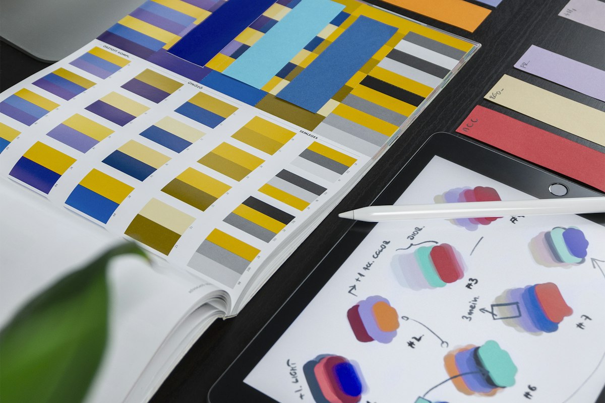 Colour swatches and tablet with interface design sketches