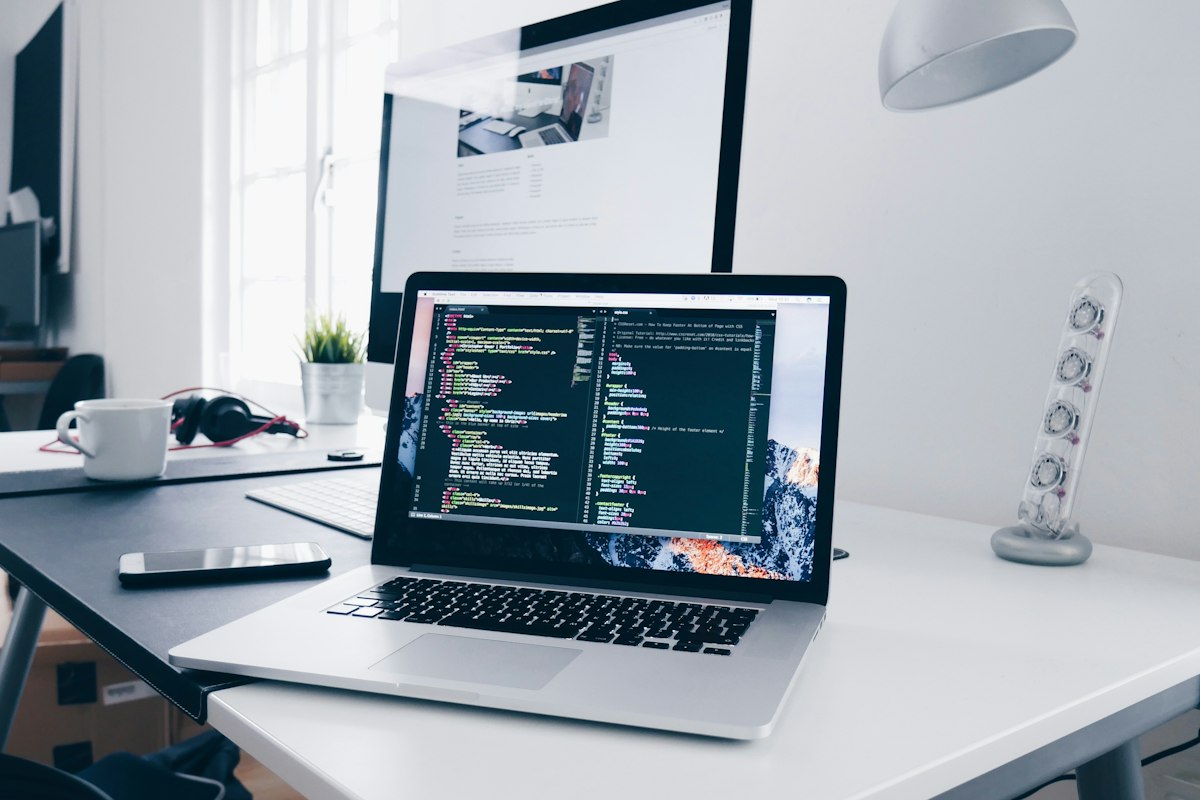 Developer desk with laptop and monitor building a web application